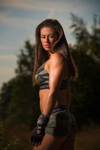 Portrait of beautiful young woman standing outdoors