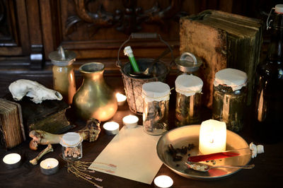 Illuminated candles on table