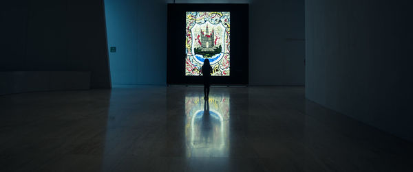 Light painting on glass wall of building