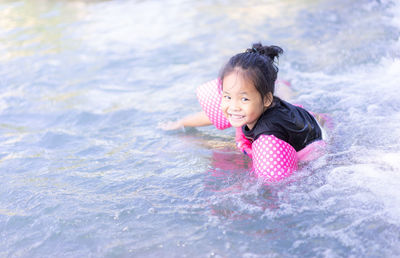 Portrait of cute girl in swimming pool