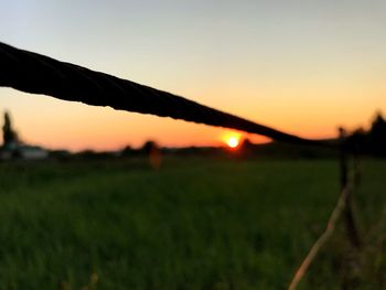 Scenic view of silhouette field against sky during sunset