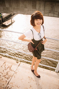 Portrait of a smiling woman standing in water