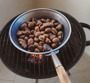 Sweet chestnuts roasting on frying pan.