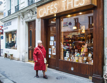 Woman walking on street in city