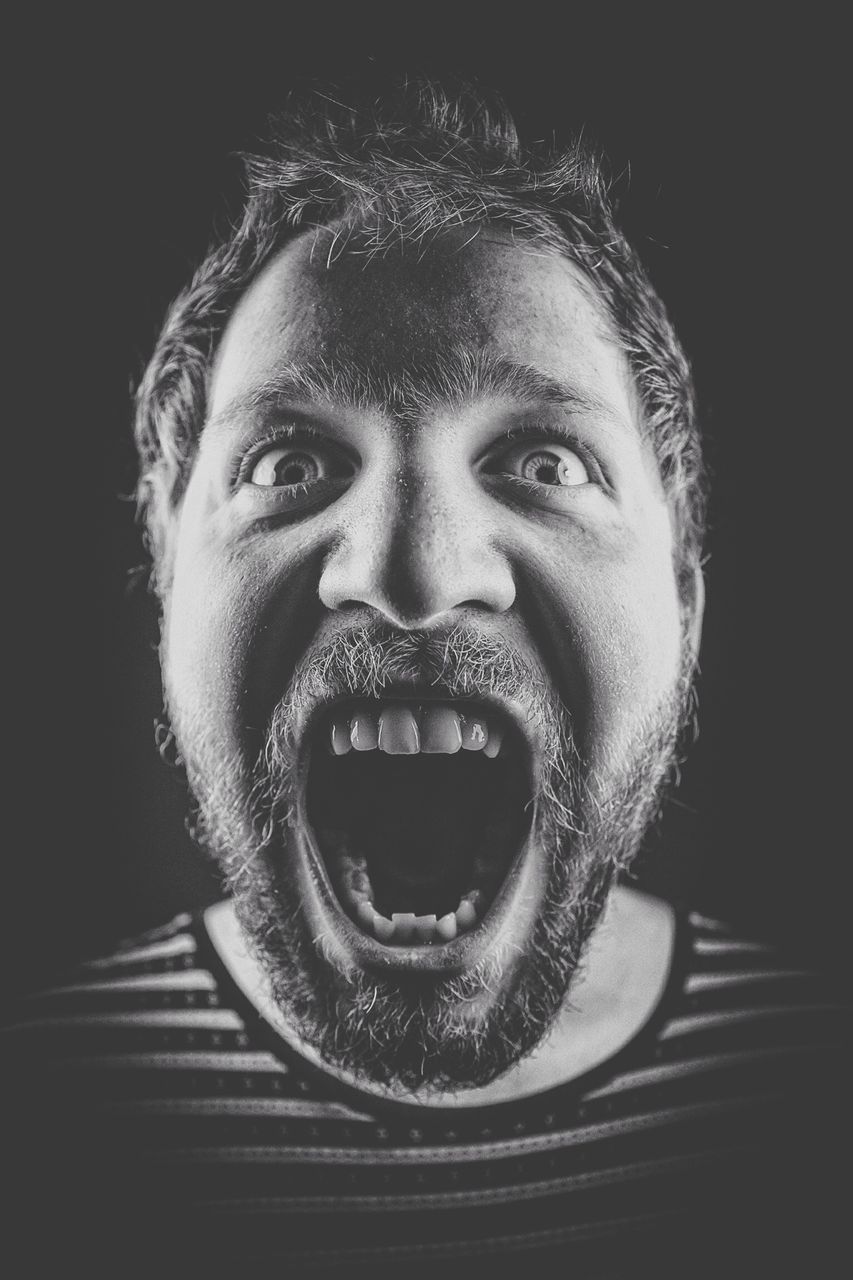 portrait, looking at camera, front view, person, young adult, headshot, indoors, close-up, lifestyles, black background, studio shot, young men, leisure activity, human face, smiling, confidence, serious, beard