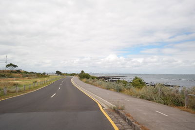 Road by sea against sky