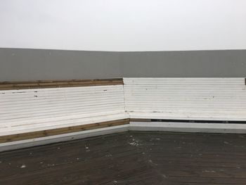 Wooden bench against wall in building