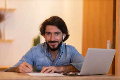 Young business man working with laptop. gray notebook for working. home office . 