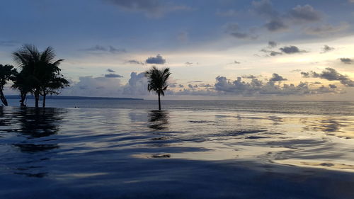 Scenic view of swimming pool against sky during sunset