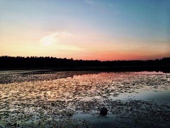 Scenic view of lake at sunset