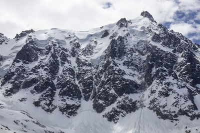 Snow covered mountains against sky