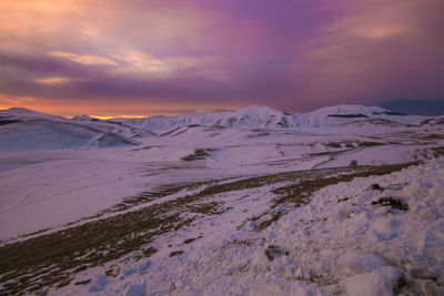 Umbria winter landscape with snow at sunset in italy