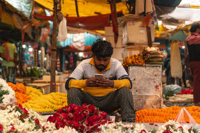 Man sitting at market stall