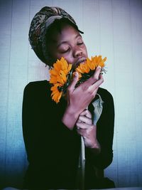 Close-up of young woman holding flower