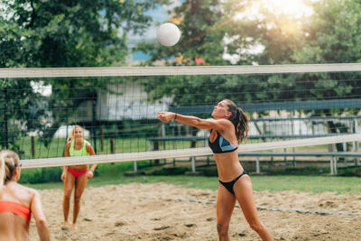 Female team playing beach volleyball