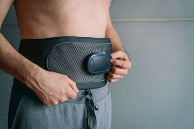 Midsection of man holding book