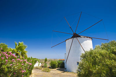 Traditional windmill against clear blue sky