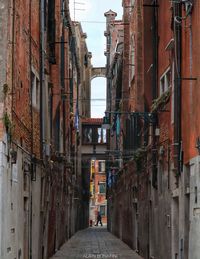 Narrow alley amidst buildings in city