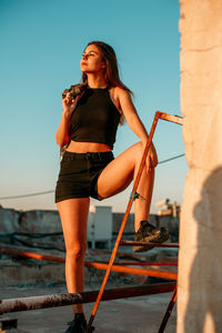 Young woman on terrace during sunset