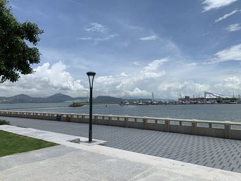 Street by sea against sky