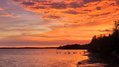 Scenic view of sea against orange sky