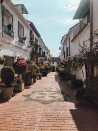 Narrow street amidst buildings in city