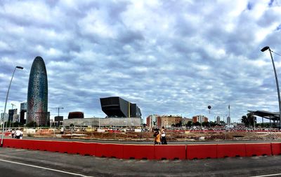 View of cityscape against cloudy sky