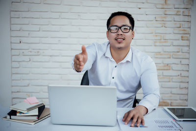 Mid adult man using laptop on table