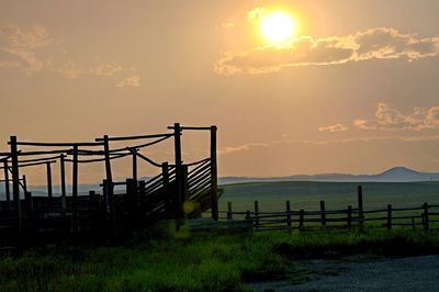 Scenic view of field against sky during sunset