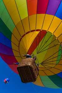 Low angle view of hot air balloons flying