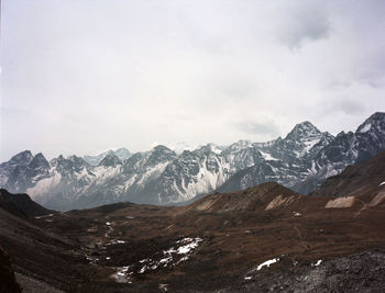 Scenic view of mountains against cloudy sky