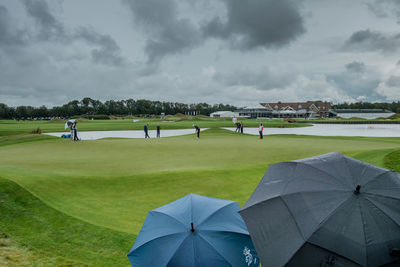 Scenic view of golf course against sky