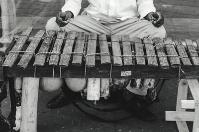 Low section of man playing music instrument