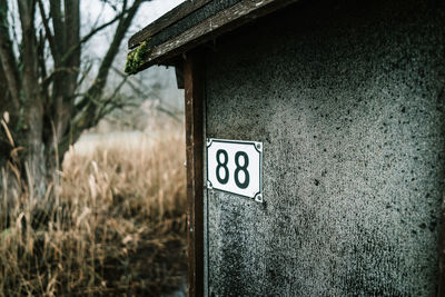 Close-up of information sign on wall