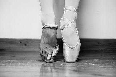 Low section of female ballerina tiptoeing