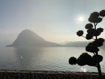 Scenic view of sea and mountains against sky