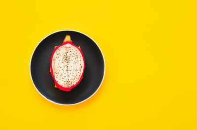 Directly above shot of drink on table against yellow background