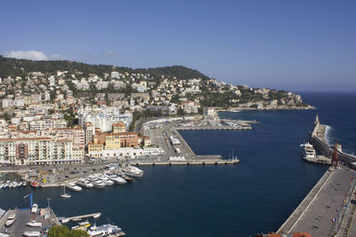 High angle view of townscape by sea against clear sky