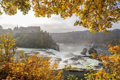 Scenic view of river against sky during autumn