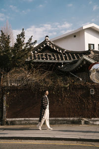 Full length of man walking by building