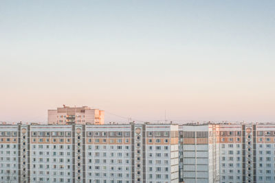 Buildings in city against clear sky