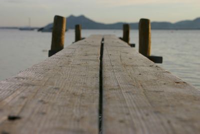 Wooden pier leading towards sea