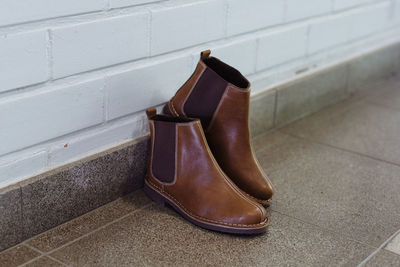 High angle view of leather shoes on tiled floor