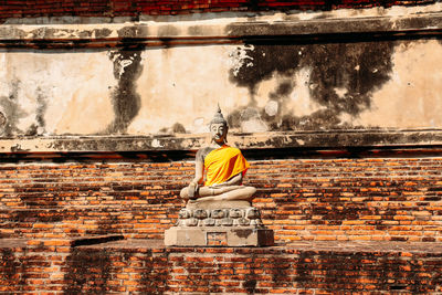 Rear view of statue against wall