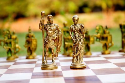 Close-up of figurines on chess board