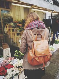 Rear view of woman standing at market stall