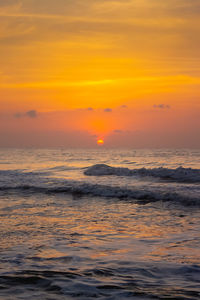 Scenic view of sea against orange sky