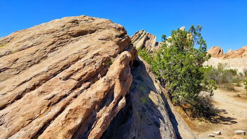 Rock formations against clear blue sky