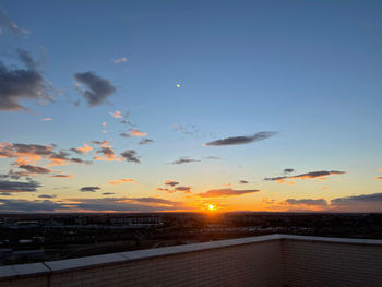 Scenic view of sunset over city