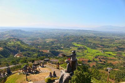 High angle view of statues by landscape against sky at bukidnon